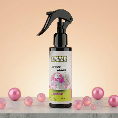 Spray bottle with 'Shocar' label on a light pink background with pink balls around